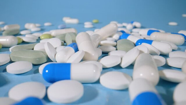 Vitamins capsules on a blue background, macro