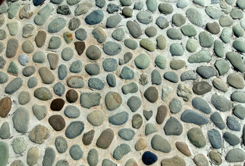 Outdoor pebble floor, massage stone walkway texture concrete wall brown floor old background decorative small stone texture