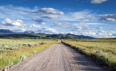 Fototapeta na wymiar Gravel road through the wilderness landscape of the Grand Teton Mountain Range Wyoming.