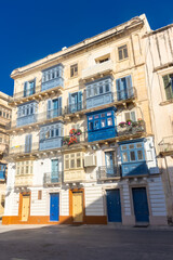 Traditional colorful maltese balconies (Gallarija) on a building in Valletta old town,  Malta