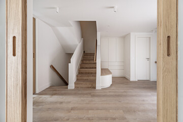 views of a large hall of a recently renovated modern house with a white oak wooden bench with...