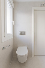 Newly built small bathroom with floating toilet next