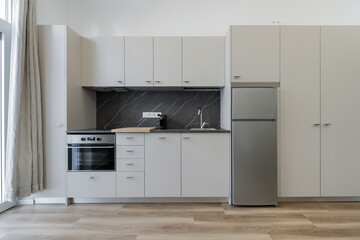 Frontal image of an open plan kitchen in a loft apartment