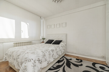 A bedroom with a double bed and a large white fabric