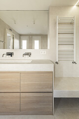 Bathroom with oak furniture, frameless mirror