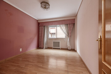 Living room with terracotta and pale pink walls, oak carpentry on doors and floors, curtains and...