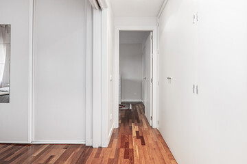 Hallway of a home with white built-in wardrobes