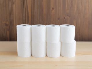 Stack of toilet paper rolls on the table - obrazy, fototapety, plakaty