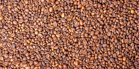 Roasted coffee beans as a background. Coffee beans macro.