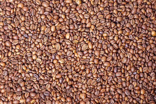 Roasted coffee beans as a background. Coffee beans macro photo.