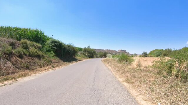 secondary paved road with a view to the castle of Monz&oacute;n, Cinca Medio, province of Huesca, Aragon, Spain