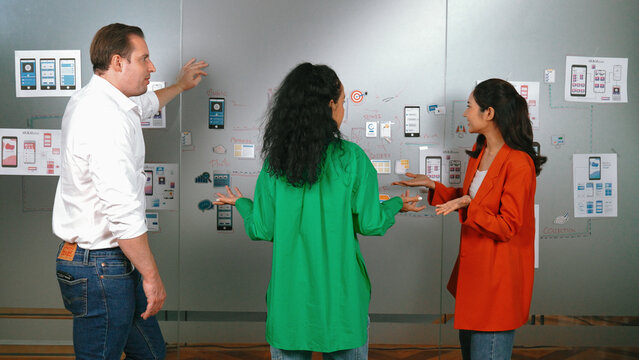 Professional business team share idea by using Ux and Ui design. Group of business people brainstorming about marketing plan. Diverse business people finding solution by using mind map. Manipulator.