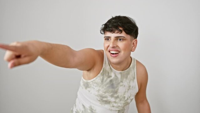 Young man, taken aback, points surprised at something ahead. wearing sleeveless t shirt, standing isolated on white, open mouth expressing pure amazement.