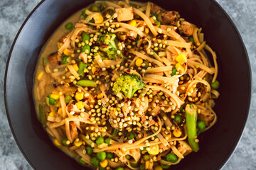 plant-based rice noodles with mixed greens and coriander seeds