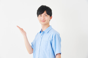 手のひらで左側を指す男性　白背景