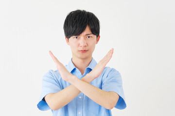 腕でばつ印をする男性　白背景