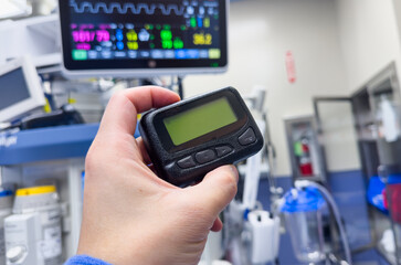 vintage pager on a busy desk, symbolizing hectic work life and essential communication in a hospital setting