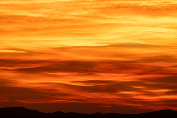 Bands of Red Orange and Yellow Span Across Sky