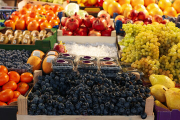 Many different fresh fruits on counter at wholesale market