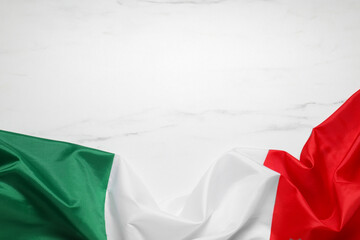 Flag of Italy on white marble background, top view. Space for text