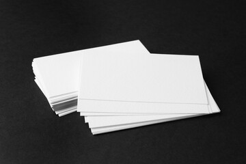 Blank business cards on black background. Mockup for design