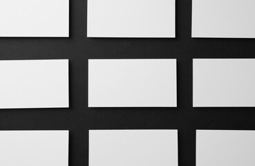 Obraz premium Blank business cards on black background, flat lay. Mockup for design