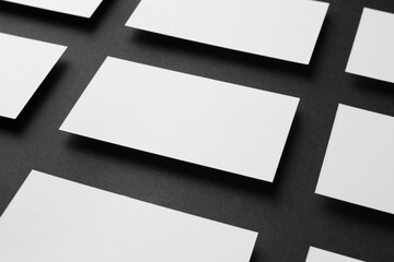 Obraz premium Blank business cards on black background, closeup. Mockup for design