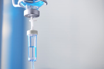 IV drip against blurred background, space for text