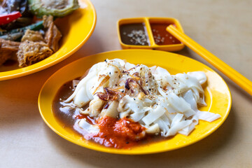 Chee Cheong Fun or Rice noodle roll served with sauces, and a sprinkle of sesame and shallot is popular Chinese food in Malaysia