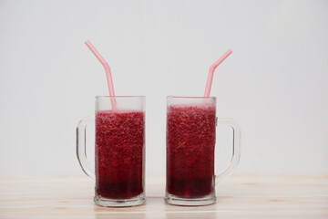Glass of red fruit smoothie with drinking straw. Concept, healthy beverage for health. Well being...
