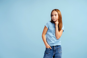 Portrait of beautiful stylish little girl wearing t shirt looking away posing isolated