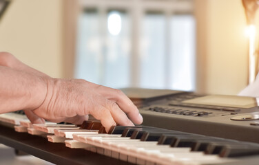 Fototapeta premium Close-up of Hands middle age man playing grand piano.