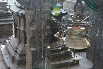 Fototapeta na wymiar Buddhist stupas and bells around Swayambhunath temple.