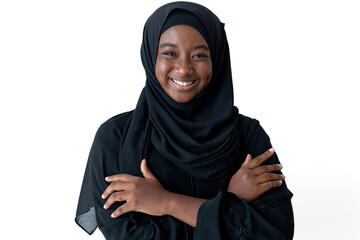 Happy African Muslim girl in black Hijab standing with arms crossed and smiling at camera on white background