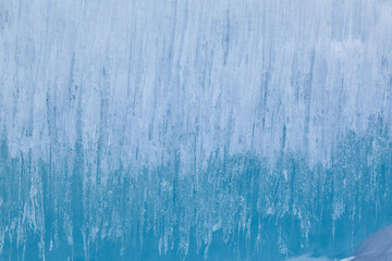 Texture of winter ice surface. Blue natural ice background
