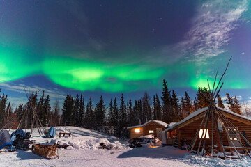 Aurora Borealis, Northern Lights, over aboriginal wooden cabin at Yellowknife, Northwest Territories, Canada © momo11353