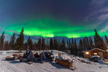 Aurora Borealis, Northern Lights, over aboriginal wooden cabin at Yellowknife, Northwest...