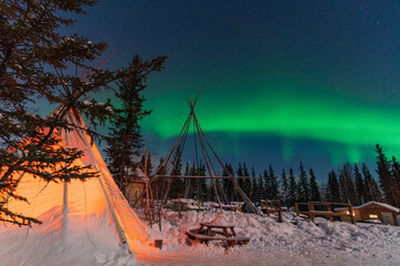 Aurora Borealis, Northern Lights, over aboriginal tent teepee at Yellowknife, Northwest...