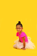 4-year-old brunette Latina girl with eyeglasses dressed in pink leotard and ballerina tutu takes ballet classes as therapy for her autism and ADHD