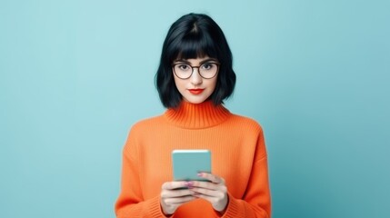 Young beautiful geeky girl with a mobile phone, round glasses, and black hair girl with an orange high-neck outfit. Generative ai