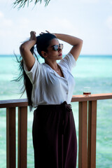 Picture of an Indian model in white dress and shades taken in Maldives