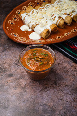 Homemade spicy red sauce for tacos. Traditional Mexican sauce in a glass bowl.