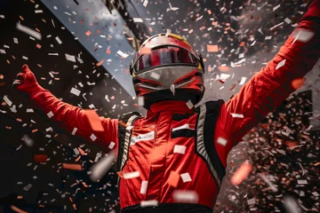 Fotobehang The winning driver of the Formula 1 car race raising his arms from the podium. Confetti flying. © Rojo