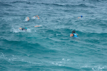 Triathlon competitions in a storm. Swimming by sea. The swimming stage.