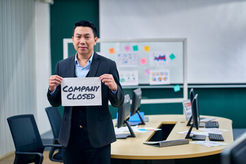 Businessman manager show wording company closed for close business concept.