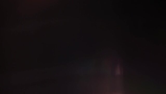 Optical flares with rainbow reflection on black background with dissolve animation 4k footage, optical flares, lens flares animation