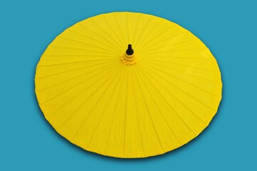 yellow umbrella isolated on blue