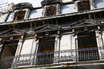 old facade with balcony of a building undergoing interior and exterior restoration
