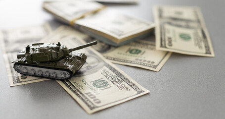 Tank on dollar bills. The concept of war costs, military spending.