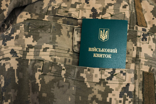 Ukrainian military id document for soldiers in pocket on pixel military uniform pattern 